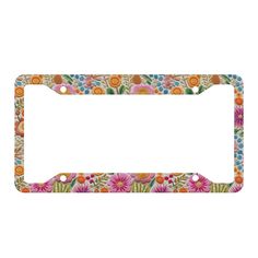 a license plate frame with flowers and leaves on the front, in multicolored colors