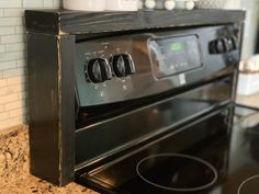 a black stove top oven sitting inside of a kitchen next to a wall mounted microwave