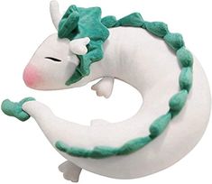 a white and green stuffed animal sitting in the shape of a crescent