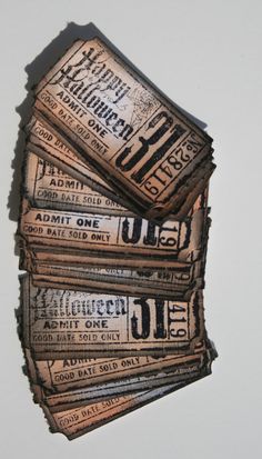 some old tickets are stacked on top of each other in the shape of a stack