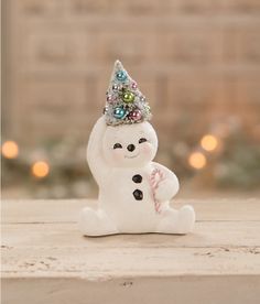 a snowman figurine with a party hat on