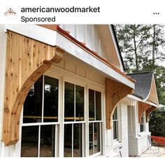 an american wood market store with wooden siding and white windows on the front of it