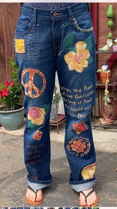 the jeans are decorated with flowers, peace signs and other things on them in different colors