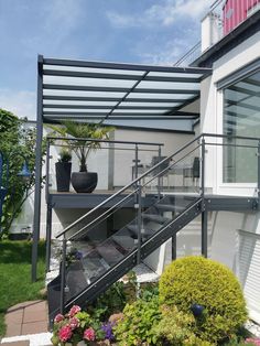 an outdoor patio with stairs and potted plants