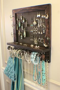 a wall mounted jewelry rack with lots of necklaces