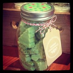 a jar filled with green candy sitting on top of a wooden table