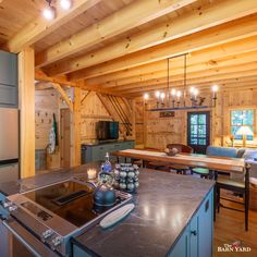 a kitchen and living room in a log cabin