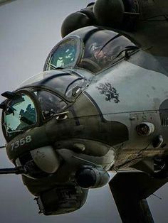 an old fighter jet is flying in the sky with it's door open and its pilot inside