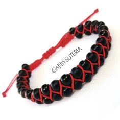 a black and red beaded bracelet on a white background with the words gaby suteria written below it