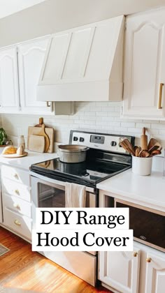 a kitchen with white cabinets and an oven in the center that says diy range hood cover