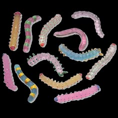 a group of toy worms sitting next to each other on top of a white surface