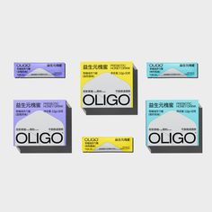 four boxes of oligo toothpaste sitting on top of each other in front of a white background