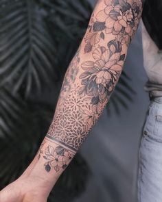 a person with a flower tattoo on their arm