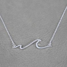 A delicate Wave/Ocean sterling silver necklace.This necklace is made of Sterling Silver and has an adjustable chain.The pendant on the necklace measures 28mm long by 7.5mm high.The chain is also sterling silver and is 15" with a 2" extension.Your necklace will be shipped in a gift box. Dinosaur Earrings, Beach Necklace, Wave Necklace, Surfer Necklace, Beach Necklaces, Ocean Jewelry, Tiny Earrings, Funky Jewelry, Ocean Wave