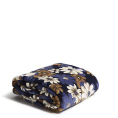 a blue blanket with white flowers on it