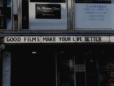 a sign that says good films make your life better on the side of a building