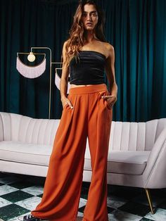 High waisted pleat front wide leg trousers with back elastic band. Designed with pleats and front pockets and finished in a chic wide-leg silhouette. Hidden side pockets. 100% polyester Made in the USA Wide Leg Pleated Pants, Wide Leg Pants High Waisted, Party Pants, Pleated Pants, Rust Color, Pant Shirt, Short Jumpsuit, Swimwear Tops, Wide Leg Trousers