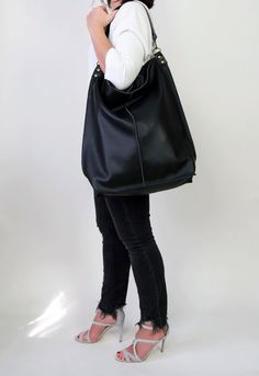 Black leather hobo This black large tote bag is made from high quality italian leather. Spacious interior provides room for all the daily essentials and more. There is an inside zippered pocket. This bag is perfect as your everyday bag, which can fit an IPAD, laptop, A4 files, books, magazines, cosmetic bag as well as many accessories. This bag has top zipper closure for safety. Height: 18,5 inch (47 cm) Width: 18,1 inch (46 cm) Length of handle: 19,3 inch (49 cm) Bottom width: 13,4x 5,5 inch (3 Black Hobo Bag With Removable Pouch For Everyday, Black Hobo Bag With Double Leather Handles, Black Hobo Bag For Everyday Use, Black Hobo Bag With Leather Handles For Errands, Black Leather Hobo Bag For Daily Use, Black Leather Hobo Bag For Errands, Everyday Black Tote Hobo Bag, Black Hobo Bag With Large Capacity, Black Hobo Bag With Removable Pouch