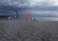 a cartoon character sitting on the beach in front of some kites