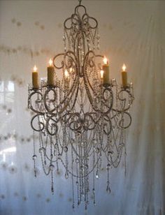 a chandelier with candles hanging from it