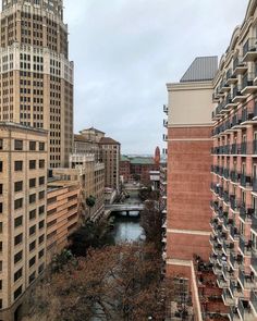 a river running through a city next to tall buildings