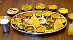 a platter filled with lots of different types of soups and condiments