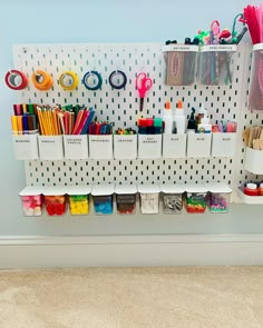 the wall is filled with craft supplies and scissors