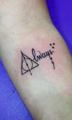 a harry potter tattoo with the word always written in cursive writing on it