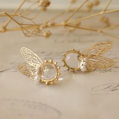 Experience the magic with our fairy wing earrings. Made from 18K gold with butterfly wing designs, these unique pieces add a whimsical touch to any outfit. Perfect for those who love fantasy-inspired jewelry. Transform your look with our fantasy inspired jewelry. Crafted from luxurious 18K gold, these earrings blend elegance and whimsy. Ideal for those seeking cute and unique accessories. Embrace ethereal elegance with our butterfly wing earrings. These 18K gold pieces feature a delicate design, perfect for adding a touch of fantasy to your style. ** Jewelry Care Guide ** Please keep it away from chemicals, store it in a dry place, avoid dropping, and seal it when not in use.  Alloy: Avoid contact with water.  18K gold and 925 silver: Clean regularly with a silver cloth.  Natural pearls: A Gold Fantasy Jewelry, Elegant Winged Earrings For Gift, Fantasy Winged Jewelry Gift, Whimsical Gold Jewelry For Pierced Ears, Fairy Style Jewelry With Matching Earrings Gift, Fairycore Jewelry With Matching Earrings For Gift, Fairy-themed Drop Earrings For Gifts, Unique Gold Wing-shaped Jewelry, Gold Fairy Earrings For Gift