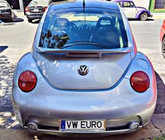 the back end of a silver volkswagen car