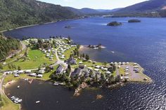 an aerial view of a lake and campgrounds in the mountains next to a body of water