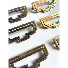 four different metal buckles on a white surface