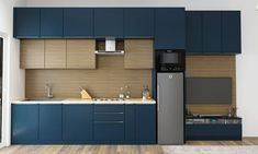 a modern kitchen with blue cabinets and wood flooring is seen in this image from the doorway