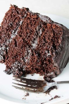 a piece of chocolate cake on a plate with a fork