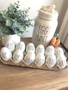 eggs are arranged in an egg carton on a table next to a potted plant