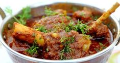 a pot filled with meat and vegetables on top of a table