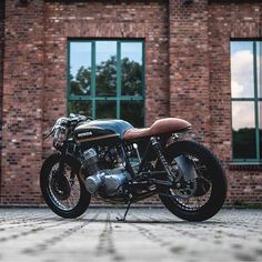 a motorcycle parked in front of a brick building