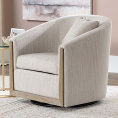 a beige chair sitting on top of a white rug