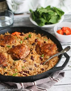 chicken and rice in a skillet on a table