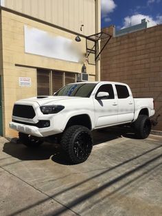 a white truck parked in front of a building