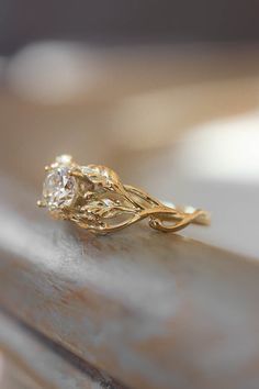 a close up of a gold ring with a diamond on it's center stone