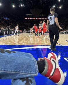 a person's feet on the court during a basketball game