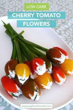 several cherry tomatoes and green beans on a white plate with the words low carb cherry tomato flowers