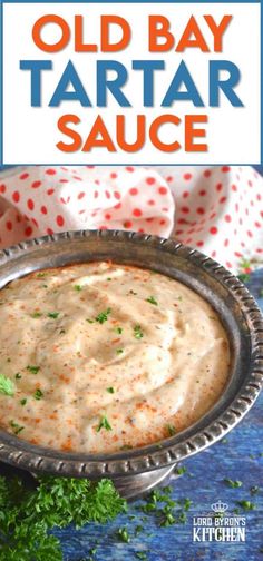 an old bay tartar sauce in a silver bowl with parsley on the side