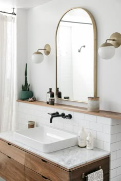 a bathroom with a sink and mirror in it