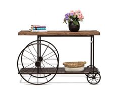 a table with a basket and flowers on it next to a bookshelf filled with books