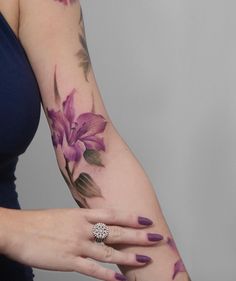 a woman with purple flowers on her arm