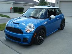 a blue car parked in front of a house