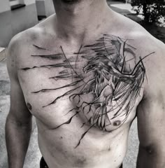 a man's chest is covered in ink and has an artistic design on it