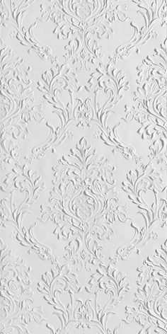 an ornate white wallpaper with intricate designs